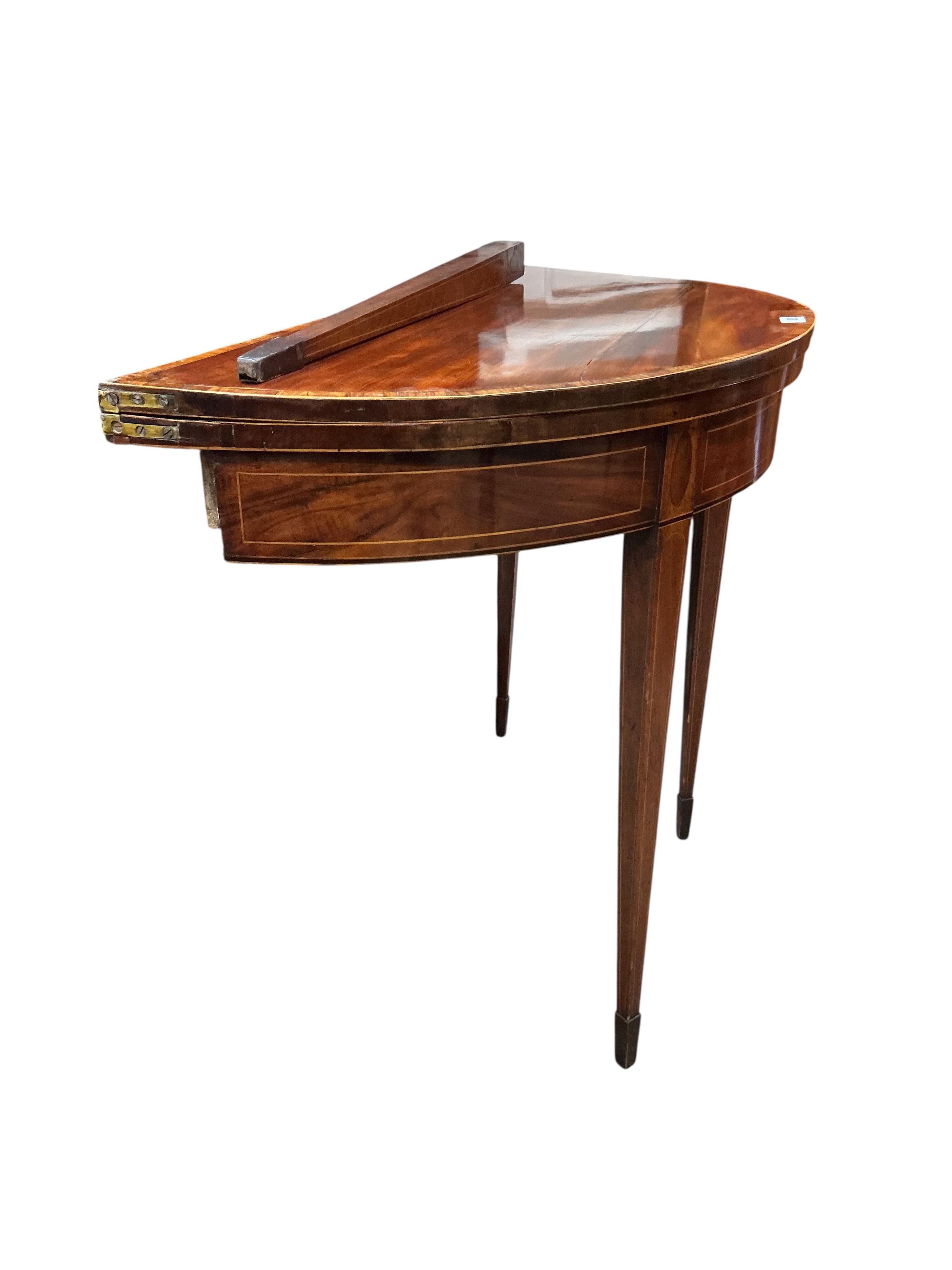 A George III tulip banded mahogany demi lune folding card table (a.f.), width 91cm, depth 45cm, height 74cm
